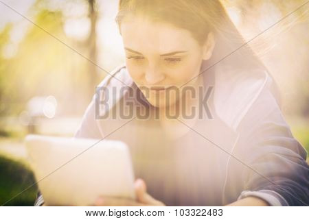 Beautiful Girl With Tablet Or Ebook Outdoor