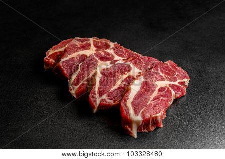 Close up pieces of raw pork on black background