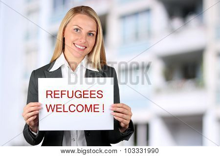 Smiling Woman Holding A White Banner With Words 