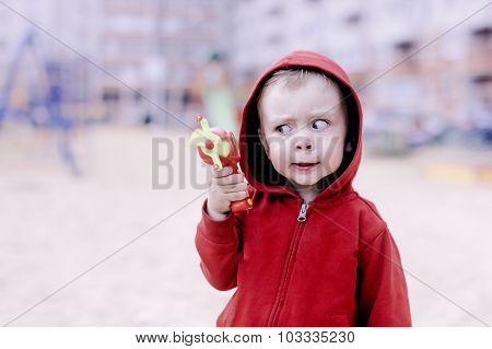 child with a toy gun