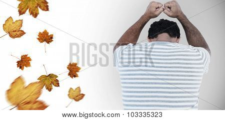 Upset man leaning on white background against autumn leaves pattern
