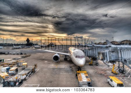 Sunset Over Commercial Aircrafts On Airport Tarmac