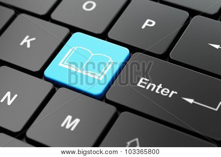 Studying concept: Book on computer keyboard background