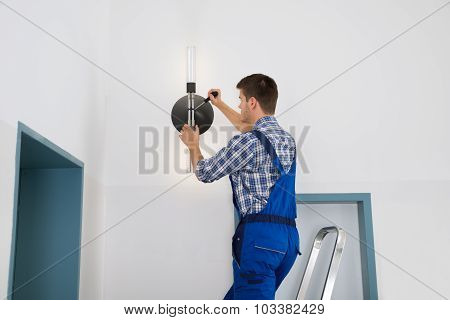 Electrician Repairing Light