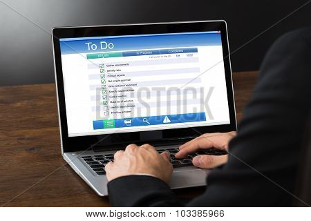 Businessperson Filling To Do List On Laptop
