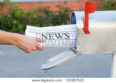 Person Hands Opening Mailbox To Remove Newspaper