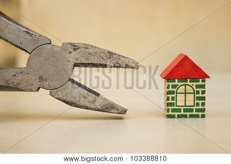 Pliers and a little house