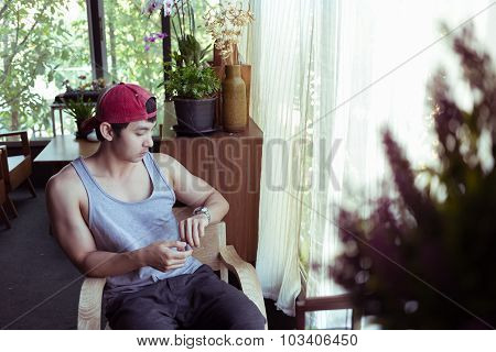 Man Sitting Waiting A Person In Coffee Cafe, Image Used Vintage Filter