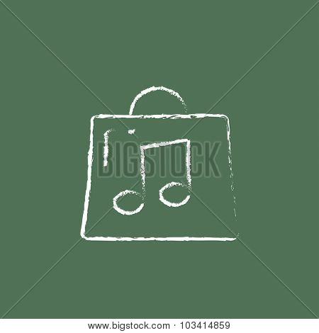 Bag with music note hand drawn in chalk on a blackboard vector white icon isolated on a green background.