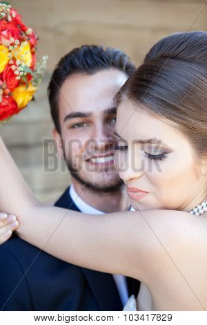 Bride Smiling While Embracing The Groom