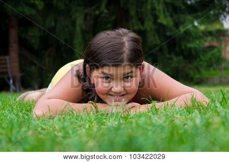 Young Girl Gypsy Child Smiling In Grass Laying
