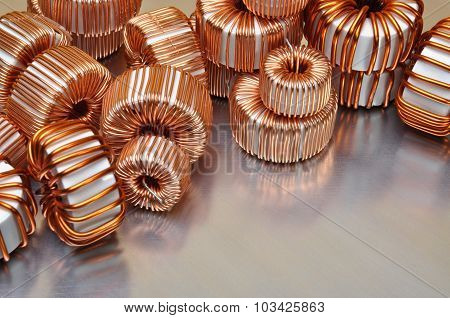 Electric copper coils on metal background