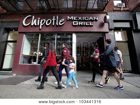 NEW YORK CITY - TUESDAY, SEPTEMBER 22, 2015: Pedestrians walk past a Chipotle Mexican fast food restaurant.  Chipotle Mexican Grill, Inc. is a chain of restaurants.