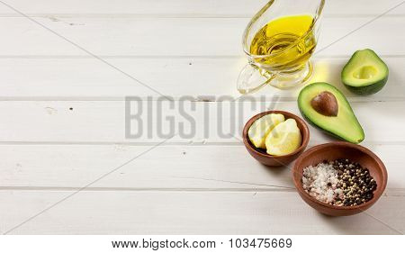 Avocado, and other ingredients for sauce guacamole on the table.