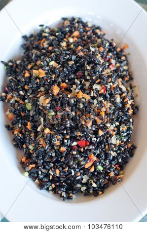 Black Rice Dish Seasoned With Tomatoes , Carrots , Olive Oil And Parsley
