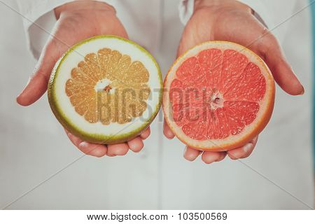 Person Human With Grapefruits In Hands.