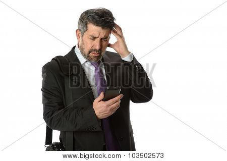 Hispanic businessman looking at cellphone with worried expression isolated over white bacgkround