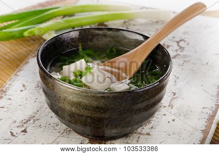 Japanese Miso Soup On A White Wooden Table.