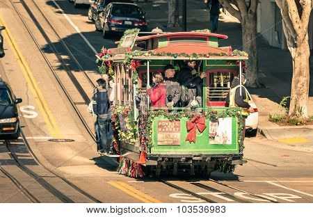 SAN FRANCISCO UNITED STATES - DECEMBER 15 2013: people riding a Powell Hyde cable car at Hyde Street. With twenty-three lines the city cable system is the world's last manually operated service.