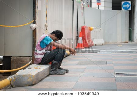 Exhausted Construction Worker Takes A Break In Singapore