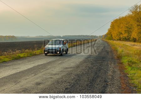 Driver of the private car saluting transport passing by on an autumnal road