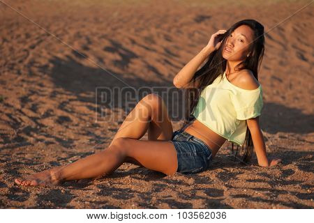 Woman sitting on the sand
