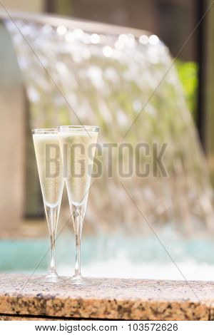 Two Glasses Of Champagne Near Outdoor Jacuzzi
