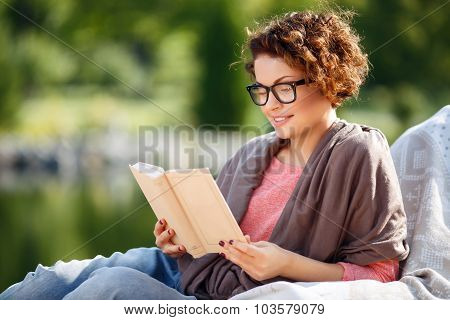 Pleasant girl reading book