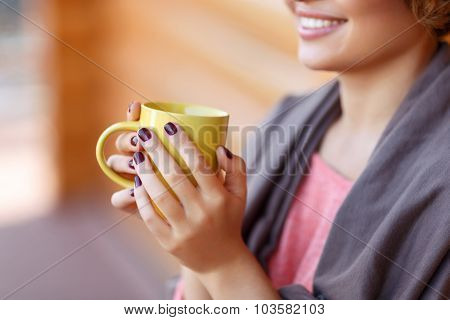 Delighted girl drinking tea