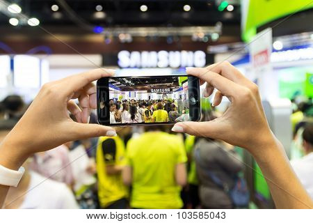 Bangkok Thailand - October 03: Hand Use Smartphone Capture Crowd In Thailand Mobile Expo Event On Oc