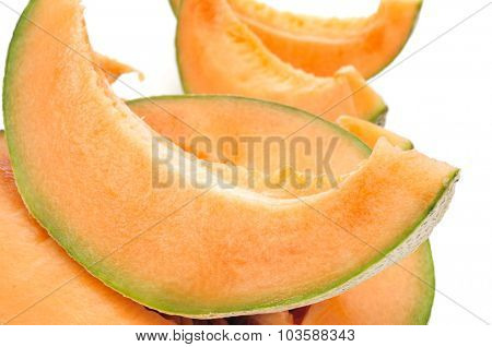 closeup of some slices of Persian melon on a white background