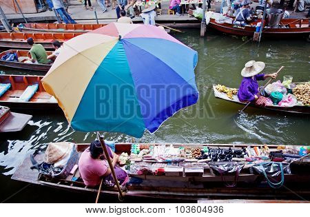 RATCHABURI THAILAND - AUGUST 28: Food vendor works on boats at the floating market on August 28 2010