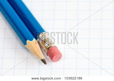 Two Pencils On The Square Paper