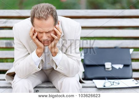 Handsome man sitting on the bench