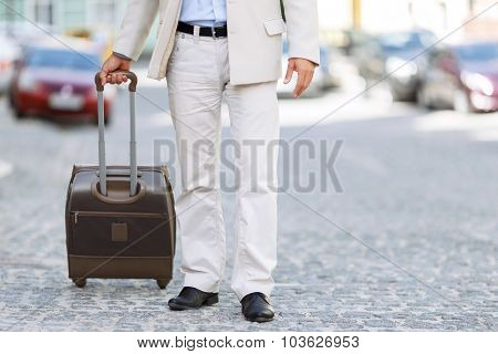 Hansome man holding his travel bag