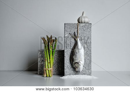 Dorada With Asparagus And Garlic And Sea Salt Presented On Stone