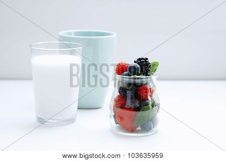 Mixed Berries And Mint In Jar And Glass Of Milk