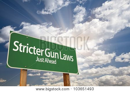 Stricter Gun Laws Green Road Sign With Dramatic Clouds and Sky.