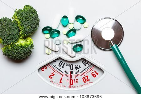 Broccoli Stethoscope Pills On Weight Scale. Dieting