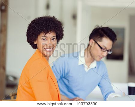 Two desingers working on a project together in office