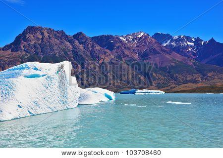 Ice and sun Patagonia, Argentina. Excursion on the tourist boat on Lake Viedma. White and blue icebergs floating near the ship broadside