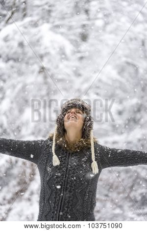 Young Woman Celebrating Winter With Her Arms Spread Widely