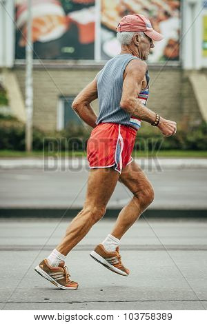 old man runner running on street