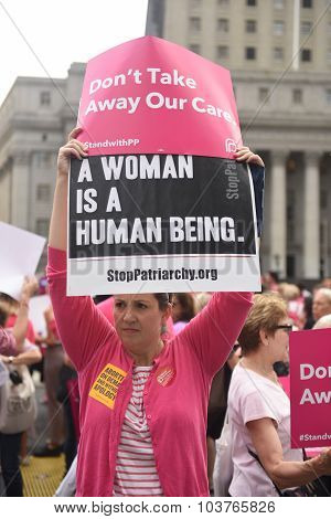 Activist with NOW & NYCPP signs
