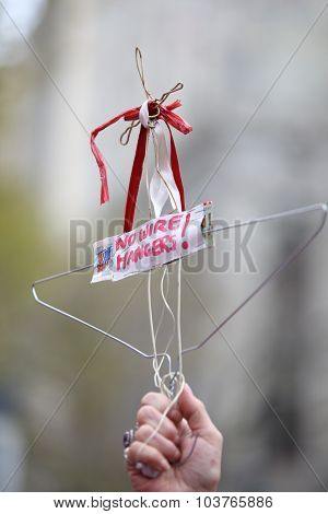 Stylized coat hanger held aloft