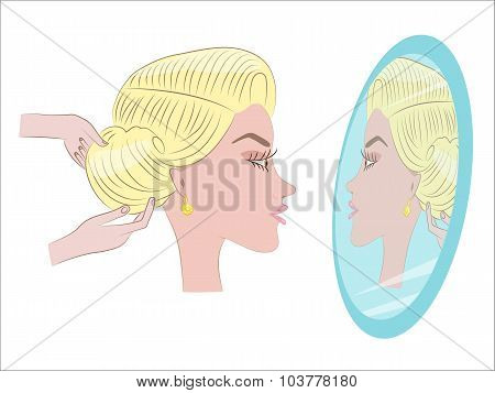 beautiful blonde getting her hair in the Barber shop in front of the mirror