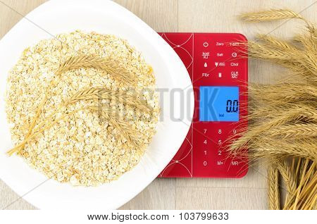 Dish Of Oatmeal On Electronic Kitchen Scales
