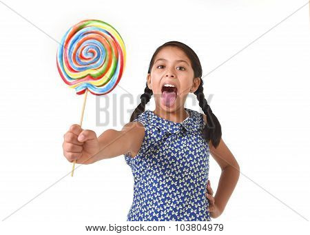 Latin Female Child Holding Huge Lollipop Happy And Excited In Cute Blue Dress And Pony Tails Candy C