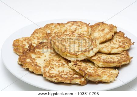 Traditional Hanukkah Potato Pancakes - Latkes - Levivot on a white plate during the Jewish Festival of Lights holiday.