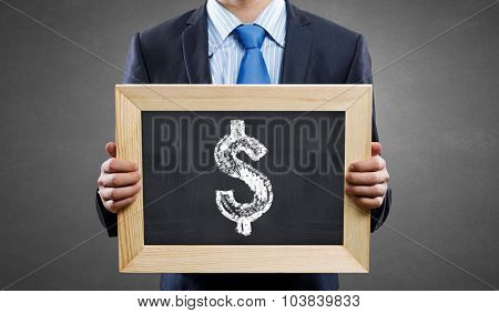 Unrecognizable businessman holding blackboard with drawn dollar concept